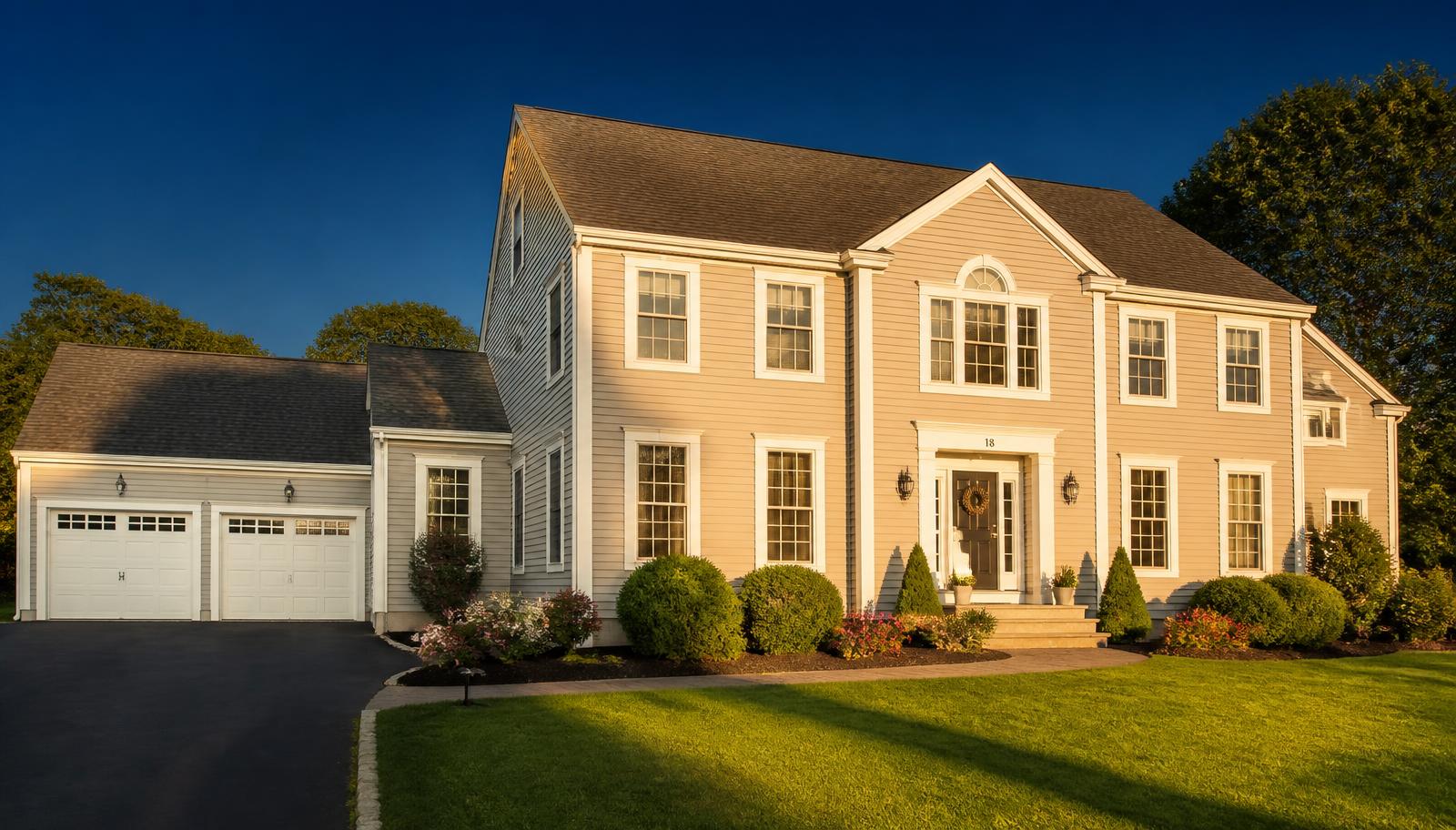 Freshly washed Connecticut colonial home at sunset